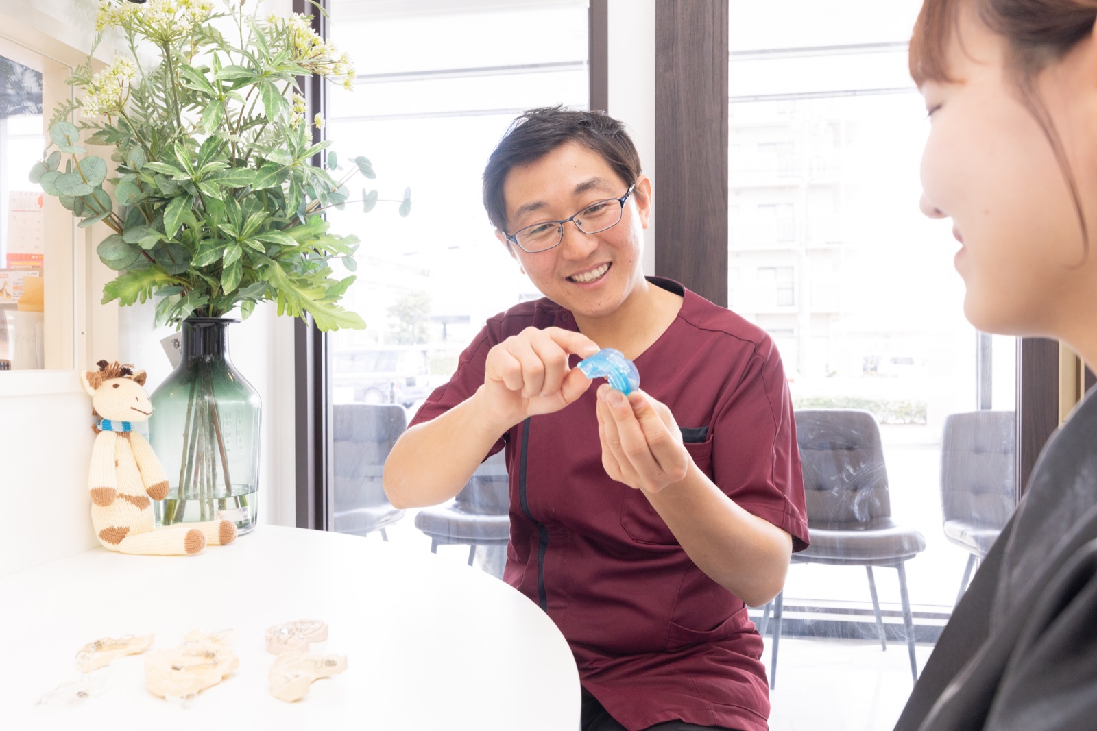 模型を手に治療について説明する歯科医師